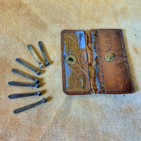 Leather cased silver shooting butt peg markers